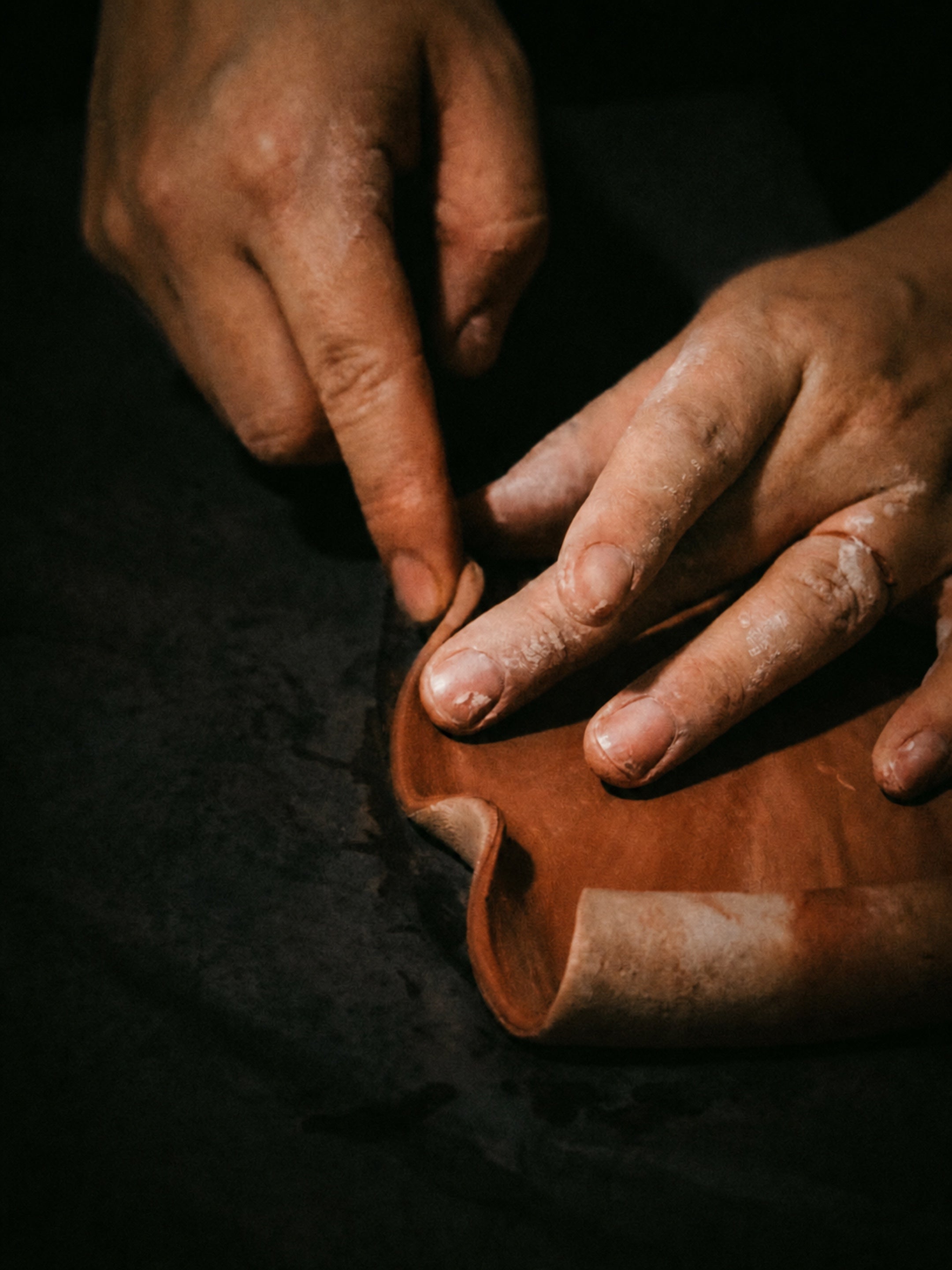 Artisan hands shaping a FuLau ceramic object